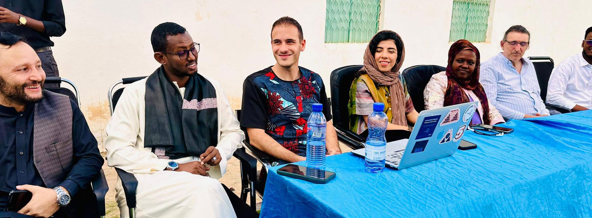 Big table with many people sitting