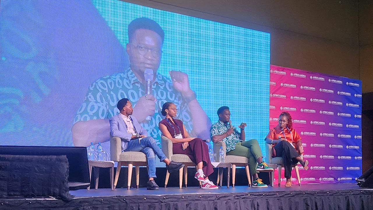 5 panelists sitting on the stage