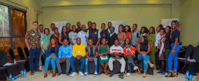 Group photo of people in an indoor setting, gathered for a training organised by Oxfam for the AU-EU Youthh Voices Lab - Power of the Collective programme.