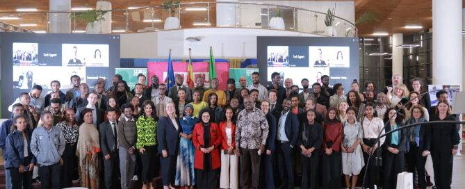 Group photo of AU-EU Youth Lab members and high-level stakeholders of the program, smiling together in a professional setting.