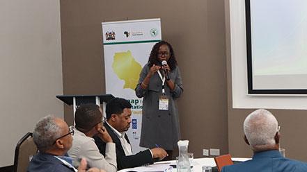 Youngwoman standing and holding a microphone